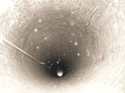 Tief unten im gemauerten Schacht schimmert das erste Wasser